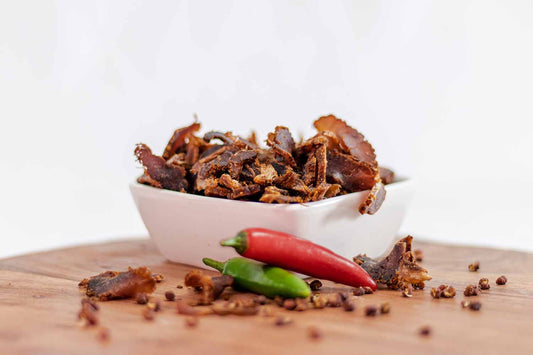Crackly's Sliced Chili 50g (10 pack) - Our sliced chili biltong offers a spicy punch that's not fierce. It marinades for 2 days in our secret Binge-Brine, packed with traditional goodness.